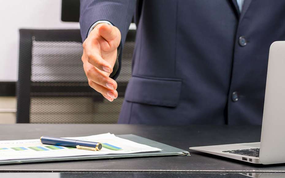 Man extending arm to shake hands