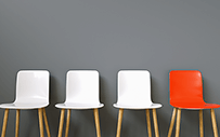 Three white chairs and one red chair.